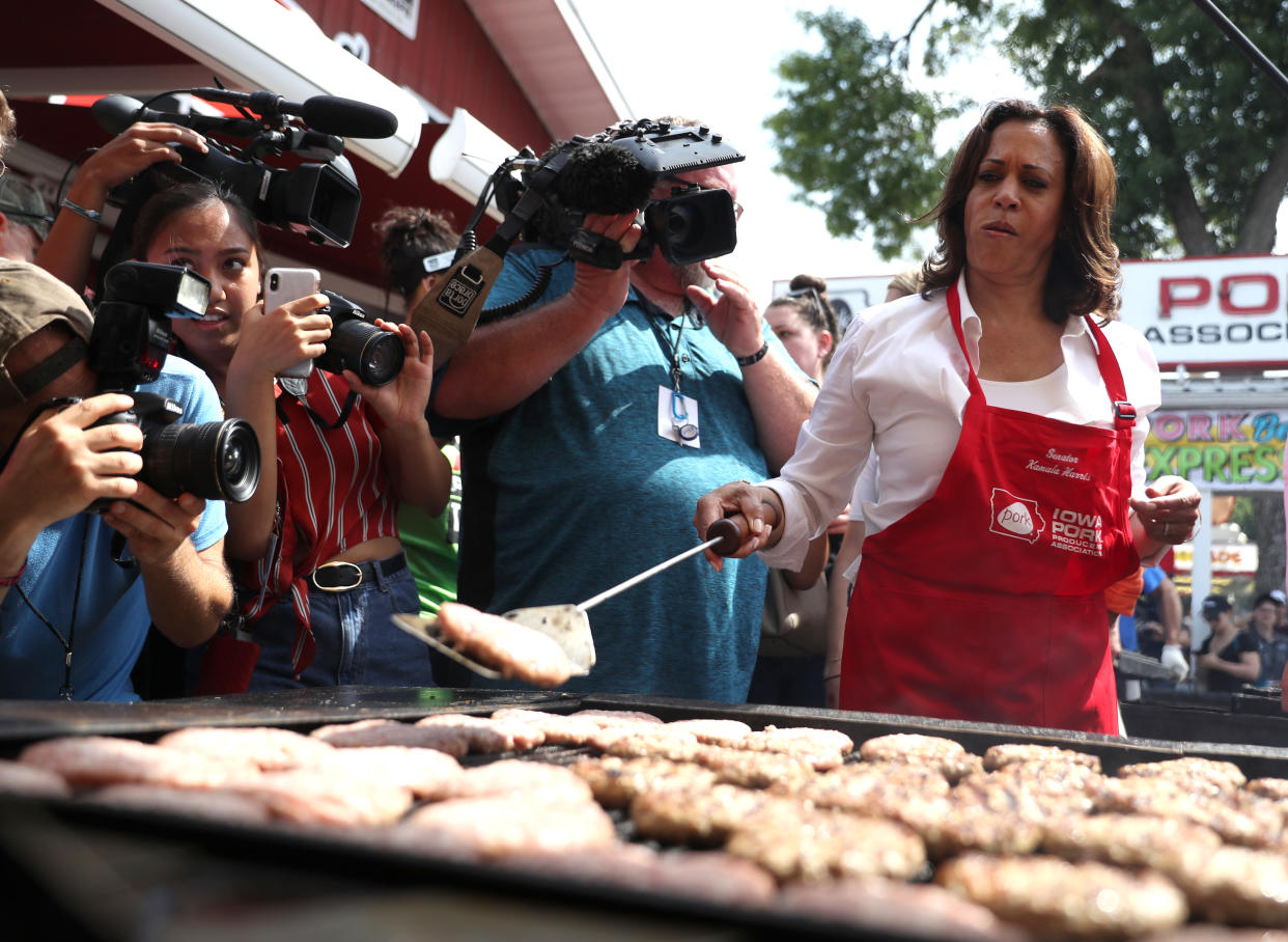 Then-U.S. Sen. Kamala Harris cooks pork burgers at the Iowa Pork Producers tent while attending the Iowa State Fair in Des Moines, Iowa, in 2019.