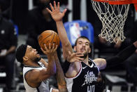 Brooklyn Nets guard Bruce Brown, left, shoots as Los Angeles Clippers center Ivica Zubac defends during the first half of an NBA basketball game Sunday, Feb. 21, 2021, in Los Angeles. (AP Photo/Mark J. Terrill)