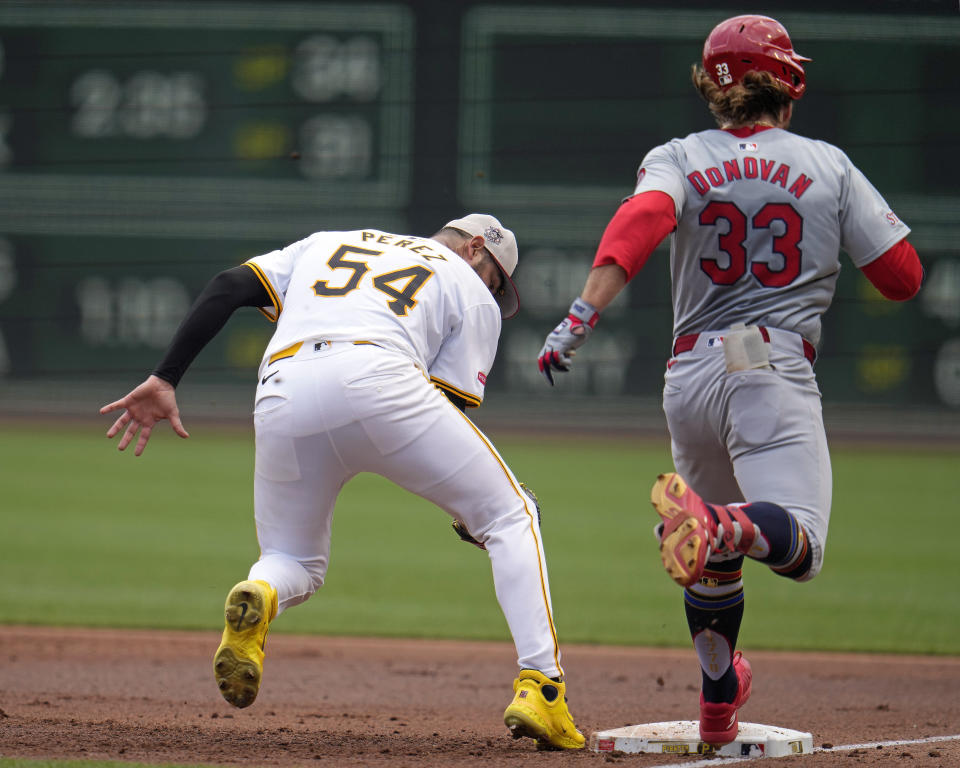 St. Louis Cardinals' Brendan Donovan (33) reaches first base safely on a fielding error by Pittsburgh Pirates starting pitcher Martín Pérez (54) during the first inning of a baseball game in Pittsburgh, Thursday, July 4, 2024. (AP Photo/Gene J. Puskar)