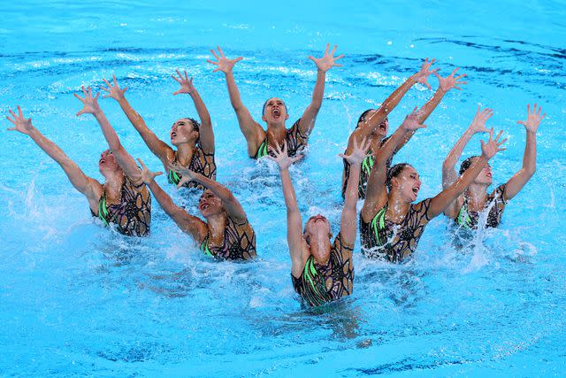 <p>Clive Rose/Getty</p> Members of Team United States artistic swimming compete in the Team Acrobatic Routine