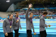 <b>Medal No. 22: </b>Michael Phelps (C) of the United States waves to the crowd celebrating his 18th gold medal for the Men's 4x100m Meldey Relay Final on Day 8 of the London 2012 Olympic Games at the Aquatics Centre on August 4, 2012 in London, England. (Photo by Jeff Gross/Getty Images)