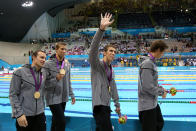 <b>Medal No. 22</b><br>Michael Phelps (C) of the United States waves to the crowd celebrating his 18th gold medal for the Men's 4x100m Meldey Relay Final on Day 8 of the London 2012 Olympic Games at the Aquatics Centre on August 4, 2012 in London, England. (Photo by Jeff Gross/Getty Images)