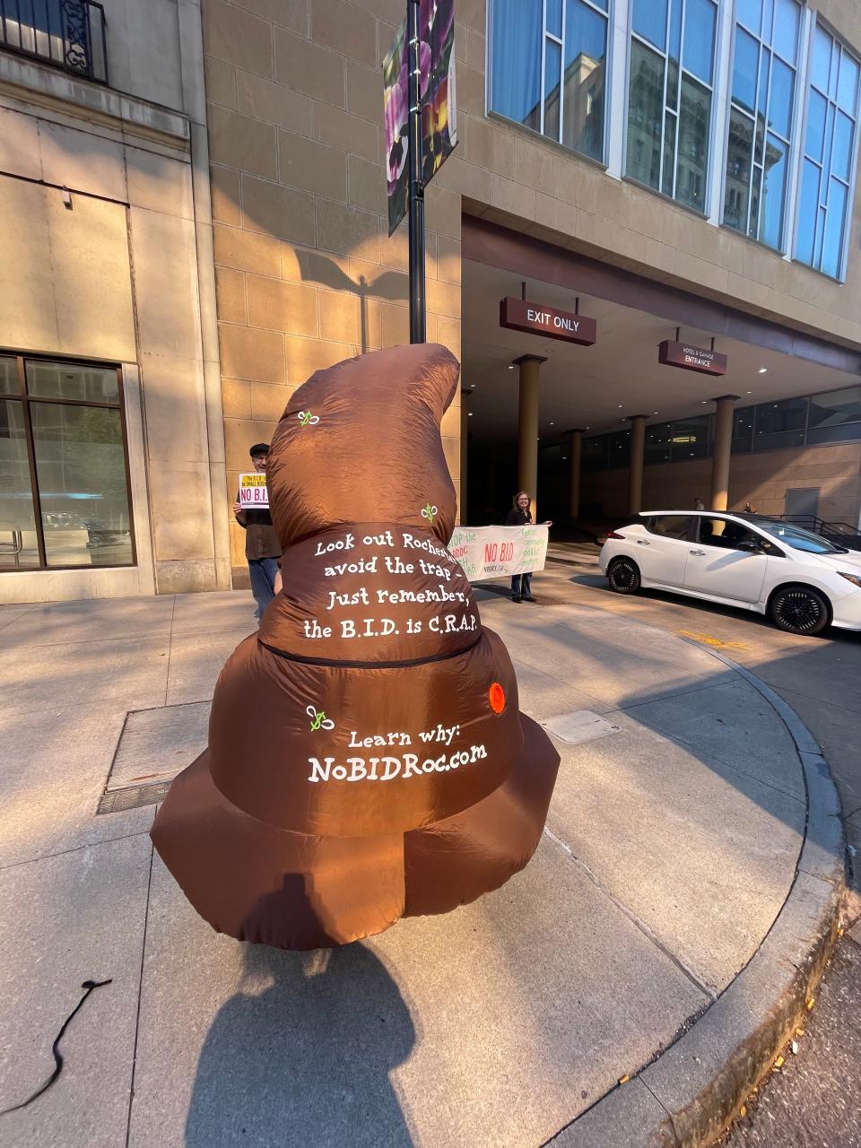 On October 2, 2023, local artist, Zie Stauffer stands outside of the Hyatt Regency in support of No BID ROC's protest of the RDDC's Business Improvement District efforts.
