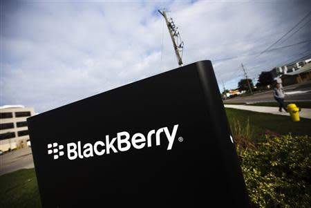 A man walks by a Blackberry sign at the Blackberry campus in Waterloo, September 23, 2013. REUTERS/Mark Blinch