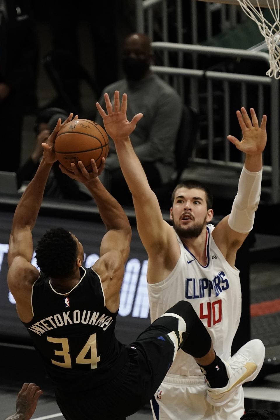 Milwaukee Bucks' Giannis Antetokounmpo is fouled as he shoots against LA Clippers' Ivica Zubac during the first half of an NBA basketball game Sunday, Feb. 28, 2021, in Milwaukee. (AP Photo/Morry Gash)