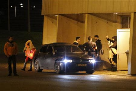 French humorist Dieudonne M'bala M'bala (R), also known as Dieudonne, waves as he leaves the Zenith concert hall where he was to hold his show in Nantes, January 9, 2014. REUTERS/Stephane Mahe