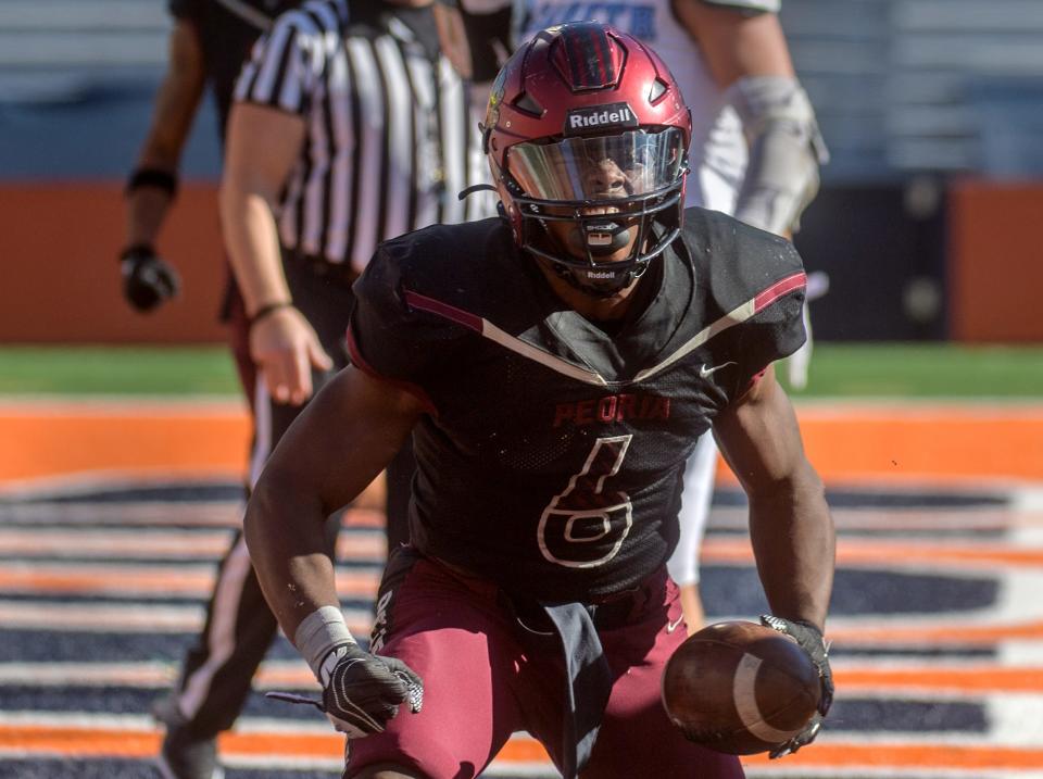 Peoria High's Malachi Washington celebrates a touchdown against Nazareth Academy in the first half of their Class 5A football state title game Saturday, Nov. 26, 2022 in Champaign.