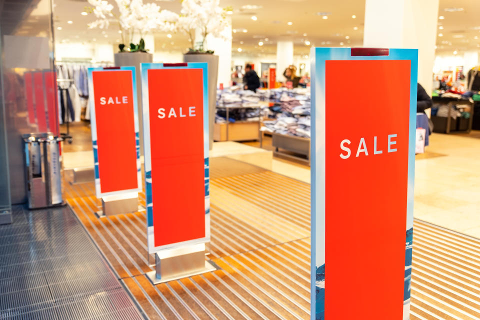 Red bright sale banner on anti-thieft gate sensor at retail shopping mall entrance. 