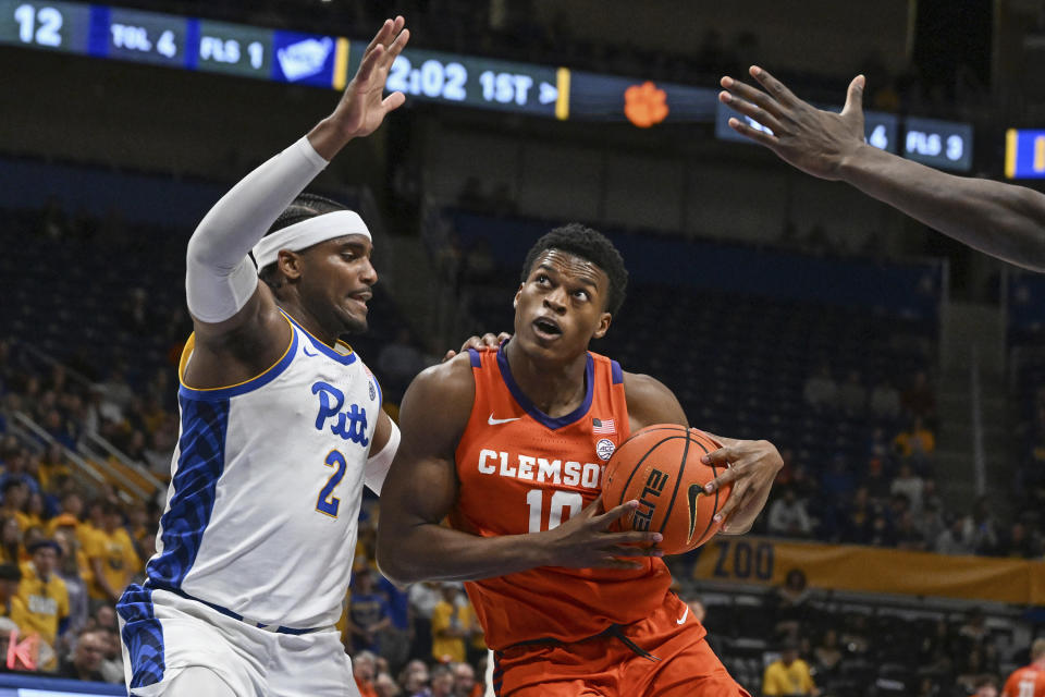 Clemson forward RJ Godfrey (10) drives past Pittsburgh's Blake Hinson (2) during the first half of an NCAA college basketball game, Sunday, Dec. 3, 2023, in Pittsburgh, Pa. (AP Photo/Barry Reeger)
