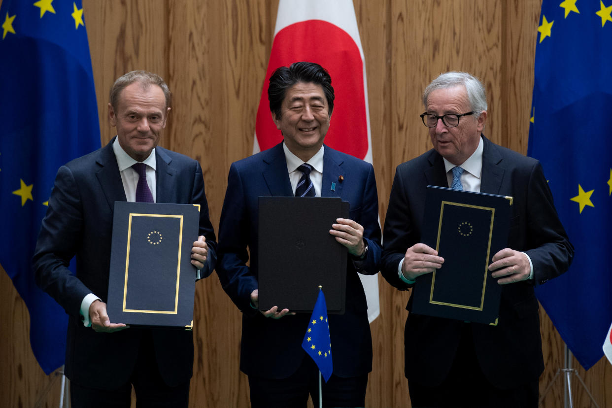 EU Council president Donald Tusk and EU Commission president Jean-Claude Juncker with Japanese prime minister Shinzo Abe (Reuters)