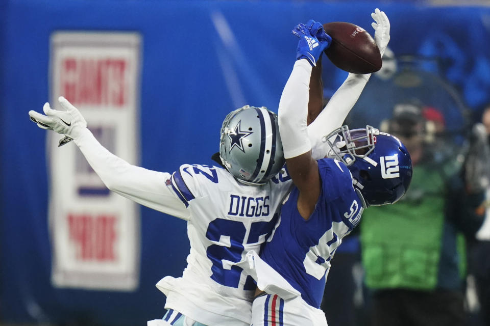 Dallas Cowboys' Trevon Diggs, left, and New York Giants' Darius Slayton fight for the ball during the second half of an NFL football game, Sunday, Jan. 3, 2021, in East Rutherford, N.J. (AP Photo/Frank Franklin II)