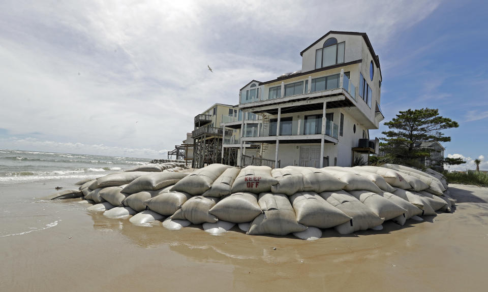 Sand bags surround homes on North Topsail Beach, N.C., Wednesday, Sept. 12, 2018, as Hurricane Florence threatens the coast. (AP Photo/Chuck Burton)