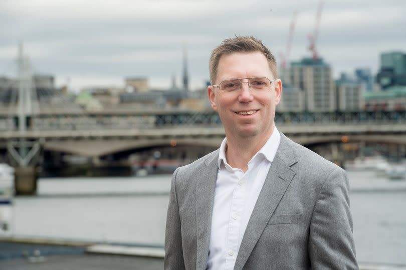 Rob Blackie with London skyline behind him