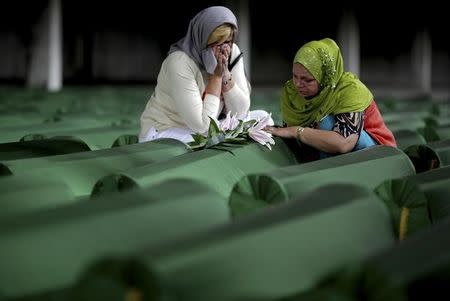 Bosnian Muslim women cry near the coffin of their relative, which is one of the 175 coffins of newly identified victims from the 1995 Srebrenica massacre, in Potocari Memorial Center, near Srebrenica, July 10, 2014. REUTERS/Dado Ruvic