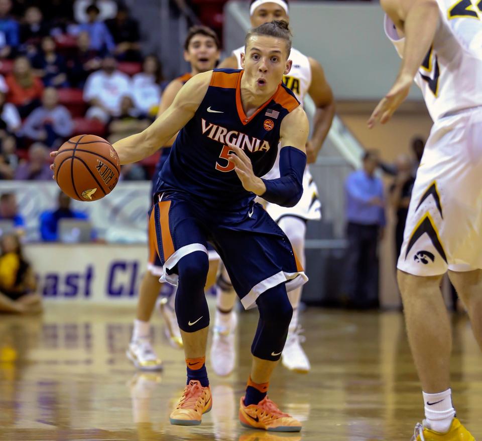 Virginia guard Kyle Guy (5) advances the ball during the second half of an NCAA college basketball game against Iowa at the Emerald Coast Classic in Niceville, Fla., Friday, Nov. 25, 2016. Virginia won 74-41. (AP Photo/Gary McCullough)