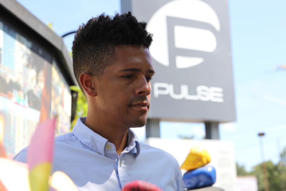 Brandon Wolf, a survivor of the Pulse nightclub shooting and activist, stands outside of the Pulse memorial in Orlando, Fla., on Sept. 9, 2022. After mass shootings, the loss felt by marginalized groups already facing discrimination is compounded. Some public health experts say the risk for post-traumatic stress disorder is greater for the groups, especially when the shootings take place at schools, churches and other vital hubs. (AP Photo/Cody Jackson)