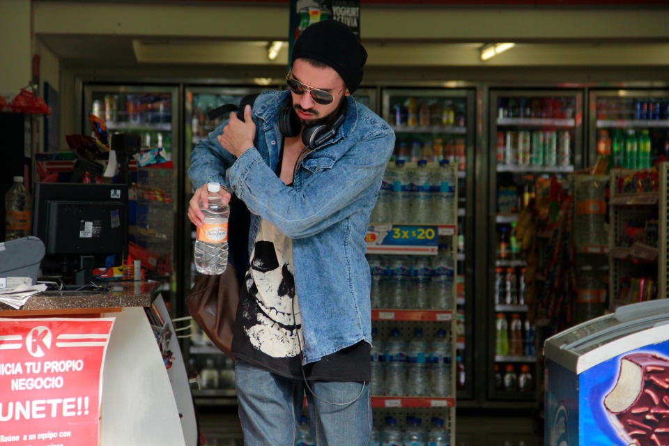 In this Jan. 9, 2014 photo, a man buys bottled water at a convenience store in Mexico City. Bad tap water accounts in part for Mexico being the highest consumer of bottled water and sweetened drinks. A law recently approved by Mexico City’s legislators will require all restaurants to install filters, offering patrons free, apparently drinkable potable water that won’t lead to stomach problems and other ailments. With an obesity epidemic looming nationwide, the city’s health department decided to back the water initiative. (AP Photo/Marco Ugarte)