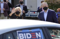 Jill Biden, front left, wife of Democratic presidential candidate former vice president Joe Biden, and Doug Emhoff, front right, husband of Democratic vice presidential candidate Sen. Kamala Harris, D-Calif., wave to supporters in passing cars during a campaign stop, Wednesday, Sept. 16, 2020, in Manchester, N.H. (AP Photo/Steven Senne)