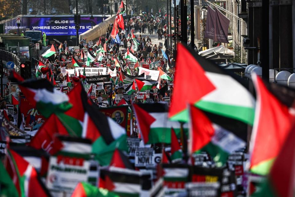 Protesters holding placards and Palestinian flags take part in a ‘National March For Palestine’ in central London on Saturday (AFP via Getty Images)