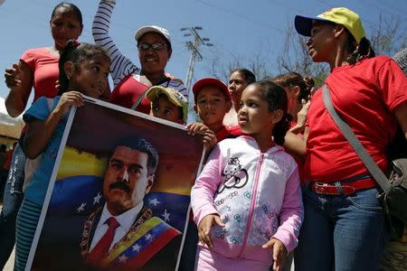 Supporters of Venezuela's President Nicolas Maduro gather in a street near the Venetur Hotel Convention Center where the 17th Non-Aligned Summit takes place in Porlamar, Venezuela September 16, 2016. REUTERS/Marco Bello