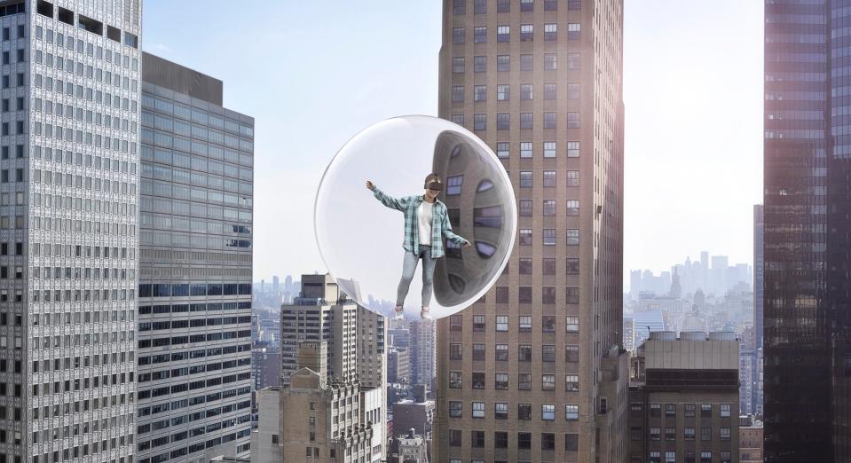 Young woman wearing a VR headset having a virtual reality experience among skyscrapers