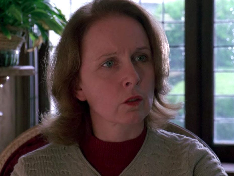 Kate Burton as Ellis Grey in Grey's Anatomy wearing a gray sweater by a window