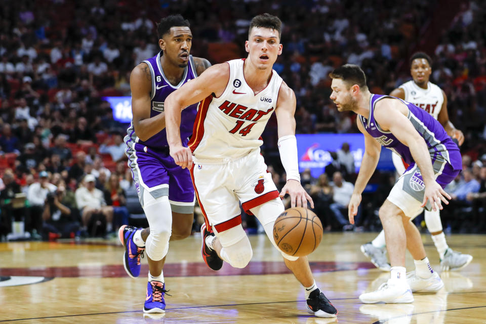 Nov 2, 2022; Miami, Florida, USA; Miami Heat guard Tyler Herro (14) dribbles ahead of Sacramento Kings guard Malik Monk (0) during the third quarter at FTX Arena. Mandatory Credit: Sam Navarro-USA TODAY Sports