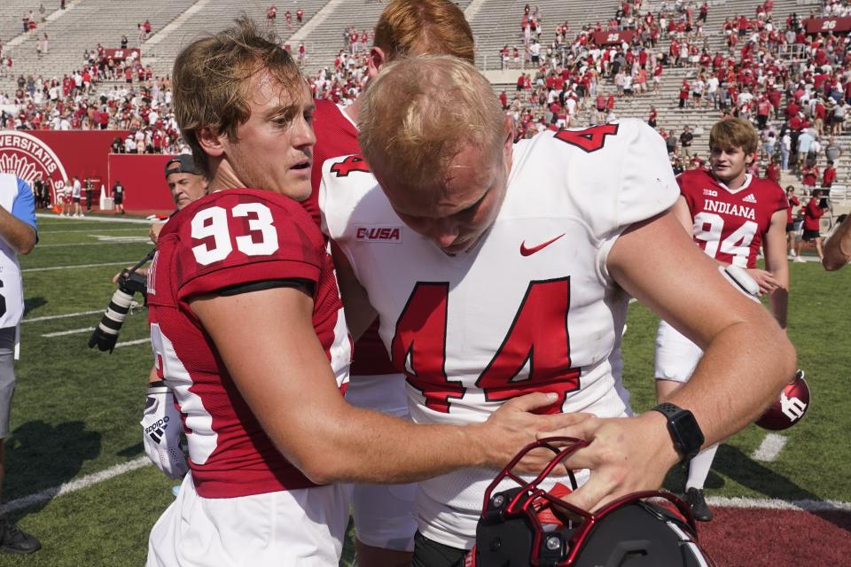 Indiana place kicker Charles Campbell (93) is congratulated by Western Kentucky place kicker Brayden Narveson (44) after Campbell kicked the game winning field goal in overtime of an NCAA college football game, Saturday, Sept. 17, 2022, in Bloomington, Ind. Indiana won 33-30 in overtime. Narveson had a field goal attempt blocked during the overtime period. (AP Photo/Darron Cummings)