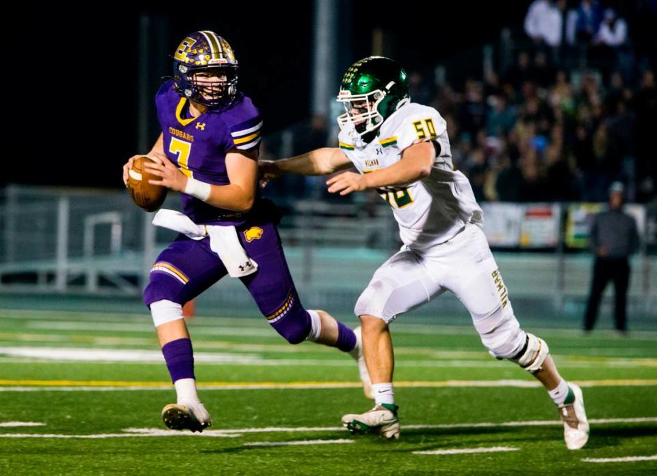 Escalon Highs Donovan Rozevink, 7, looks up field as Hilmar Highs Nicholas Vitorino, 50, closes in. Escalon High School took on Hilmar High football during the 2021 CIF Sac-Joaquin Football Playoffs - Division V at Saint Mary’s High School in Stockton, Ca. Escalon came out on top as the champions with a 20-13 win over Hilmar.