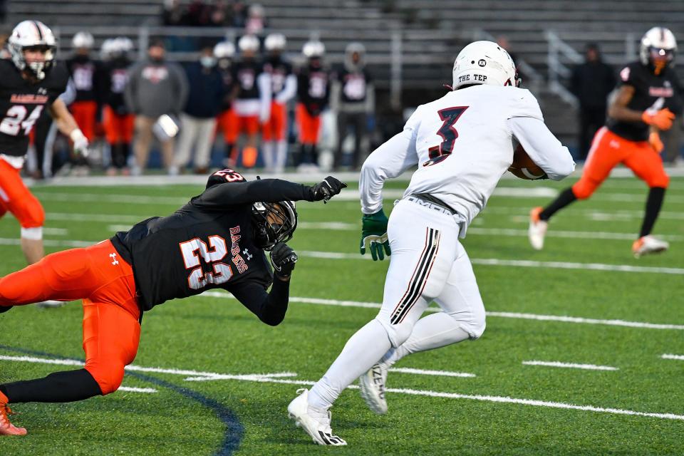 Cathedral Prep's Rayfes Roberts Jr #23 finds Imhotep's Stanley "Tre" McLeod #3, just out of reach in the 3rd quarter of the PIAA Class 5A quarterfinal football game on Saturday at the Bald Eagle Area High School in Wingate, Centre County. The Ramblers lost to the Panthers, 42-7.