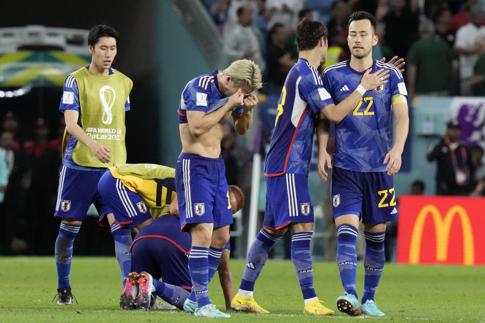 Japan players are dejected after Croatia's win in the World Cup round of 16 soccer match between Japan and Croatia at the Al Janoub Stadium in Al Wakrah, Qatar, Monday, Dec. 5, 2022. (AP Photo/Eugene Hoshiko)