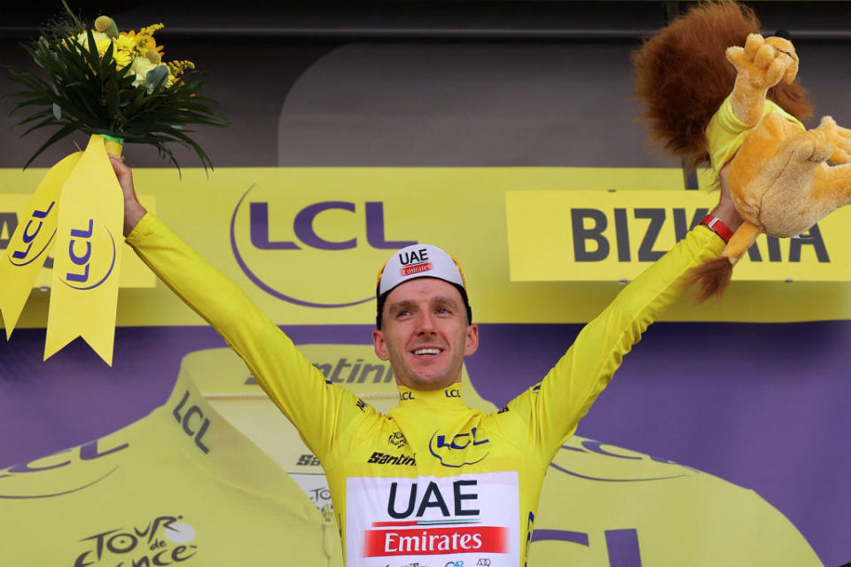 UAE Team Emirates British rider Adam Yates celebrates on the podium with the overall leaders yellow jersey after the 1st stage of the 110th edition of the Tour de France cycling race 182 km departing and finishing in Bilbao in northern Spain on July 1 2023 Photo by Thomas SAMSON  AFP Photo by THOMAS SAMSONAFP via Getty Images