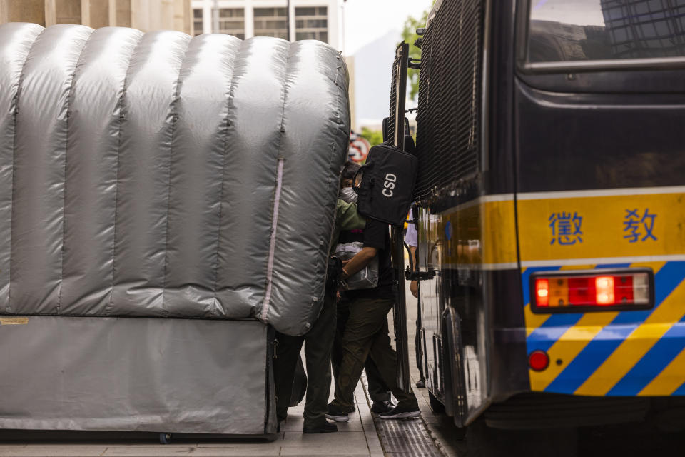 Detained activist Jimmy Sham, center, leaves a prison van to enter the Court of Final Appeal as Hong Kong's top court hear the activist's last bid to ask for recognition of his New York-registered same-sex marriage in Hong Kong, Wednesday, June 28, 2023. (AP Photo/Louise Delmotte)