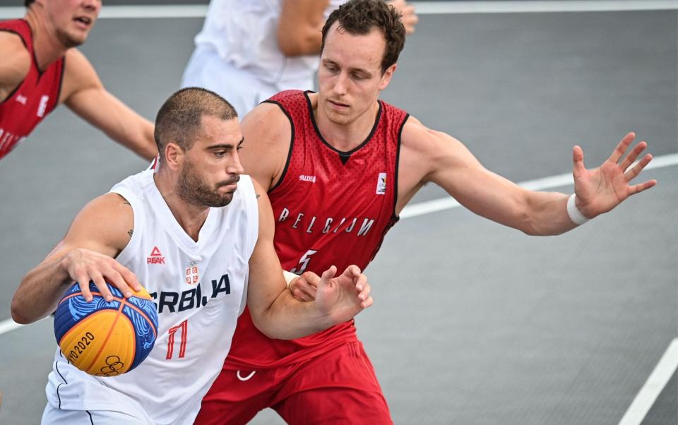 Serbia's Dusan Bulut (left) dribbles past Belgium's Nick Celis - GETTY IMAGES