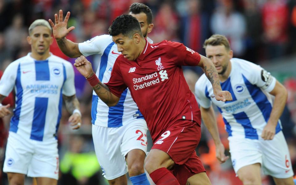 Roberto Firmino runs at the Brighton defence - REUTERS