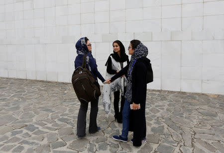 Female students of American University of Afghanistan chat with each other as they arrive for new orientation sessions at a American University in Kabul. REUTERS/Mohammad Ismail