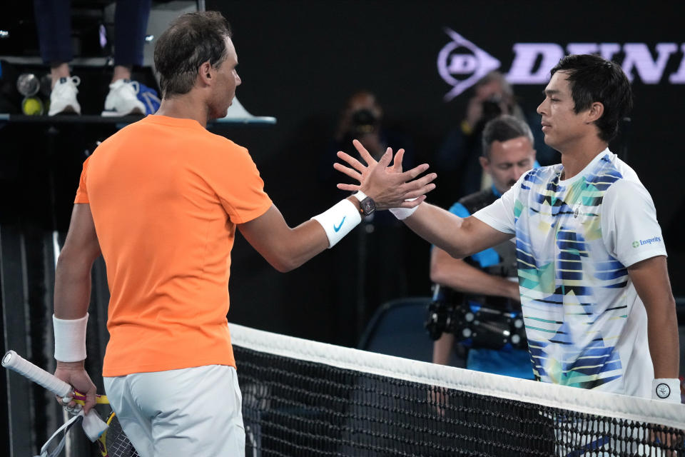 Rafael Nadal, left, of Spain congratulates Mackenzie McDonald of the U.S., following their second round match at the Australian Open tennis championship in Melbourne, Australia, Wednesday, Jan. 18, 2023. (AP Photo/Dita Alangkara)