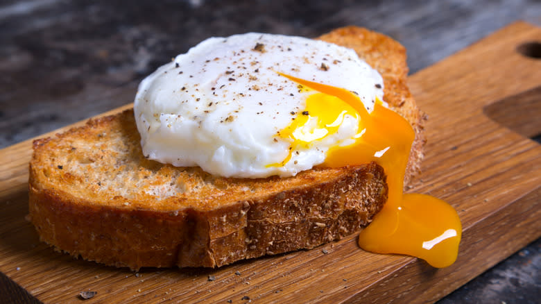Poached egg on toast leaking yolk