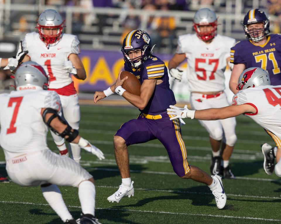 Jackson quarterback Lucas Ecrement keeps the ball in the first quarter against Mentor at home last Friday.