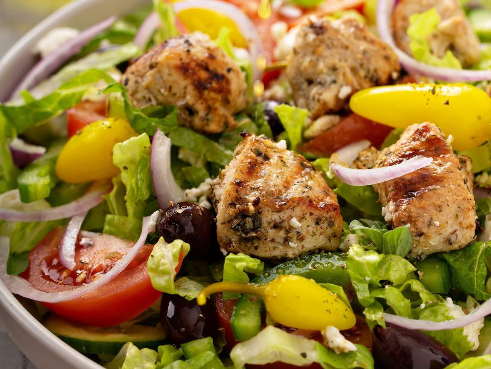Greek salad with grilled chicken with herbed vinaigrette dressing.