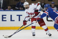 Carolina Hurricanes center Vincent Trocheck (16) passes against New York Rangers defenseman Adam Fox (23) during the second period of Game 6 of an NHL hockey Stanley Cup second-round playoff series, Saturday, May 28, 2022, in New York. (AP Photo/John Minchillo)