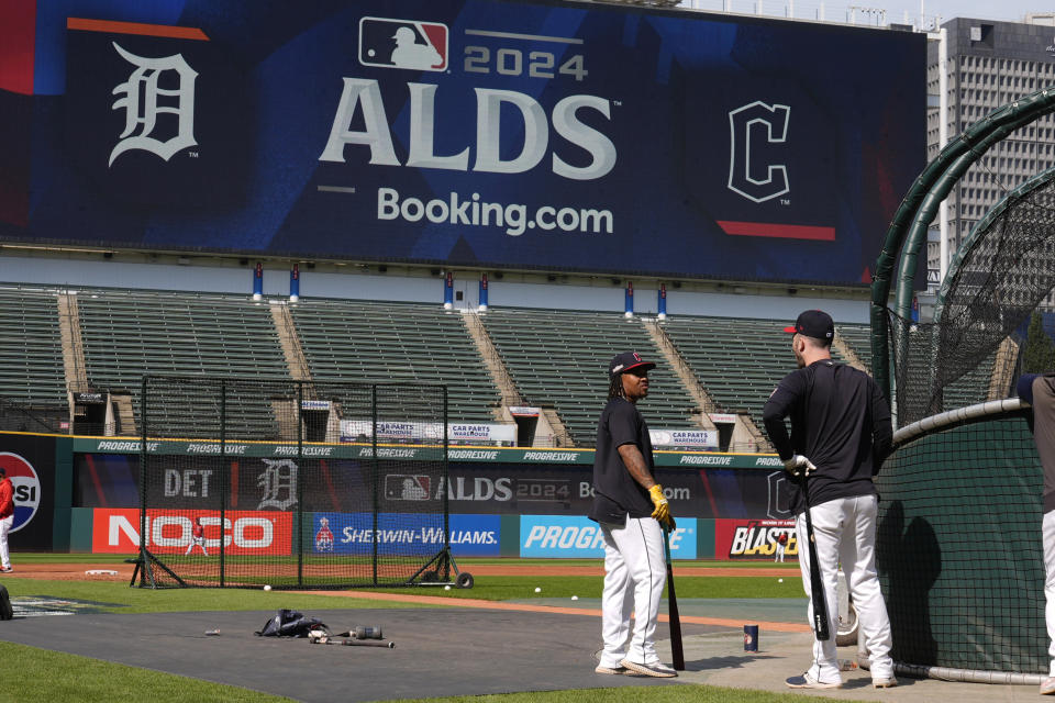 Cleveland Guardians' Jose Ramirez, left, and David Fry, right, talk near the batting cage during a baseball workout in Cleveland, Friday, Oct. 4, 2024, in preparation for the American League Division Series against the Detroit Tigers. (AP Photo/Sue Ogrocki)