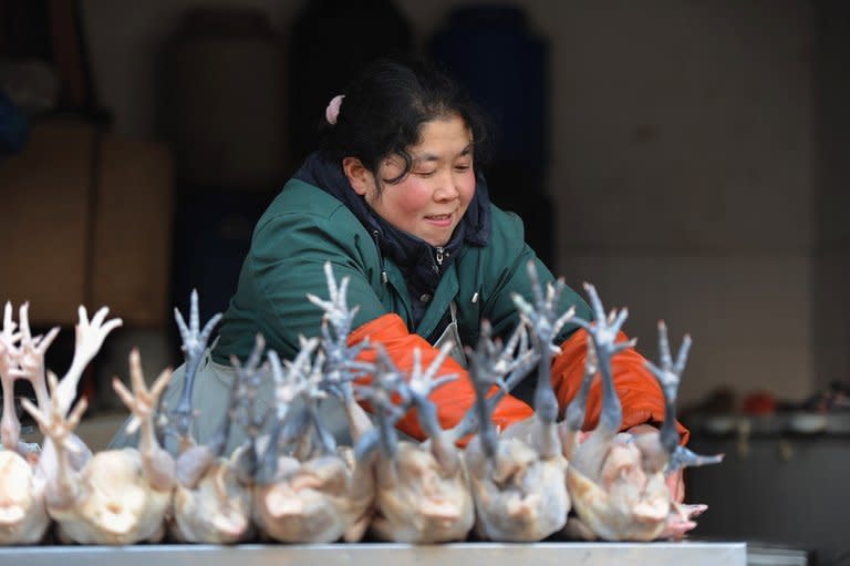 A market holder sells chickens in Hefei, central China, on January 11, 2013. Chinese inflation rose more than expected to hit a 10-month high in February, official data showed, as holiday season spending and rapid credit growth accelerated price rises