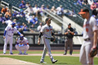 Baltimore Orioles starting pitcher Matt Harvey, center, looks to the outfield with a Mets runner on third during the fifth inning of a baseball game, Wednesday, May 12, 2021, in New York. Harvey allowed seven earned runs in four and a third innings against his former team. (AP Photo/Kathy Willens)