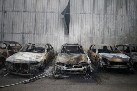 Burnt vehicles are seen after a forest fire in Miro, near Penacova, Portugal, October 17, 2017. REUTERS/Pedro Nunes