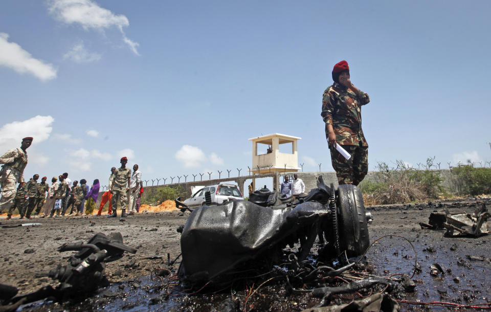 Somali security forces attend the scene after an attack on a European Union military convoy in the capital Mogadishu, Somalia Monday, Oct. 1, 2018. A Somali police officer says a suicide car bomber has targeted a European Union military convoy carrying Italian military trainers in the Somali capital Monday. (AP Photo/Farah Abdi Warsameh)