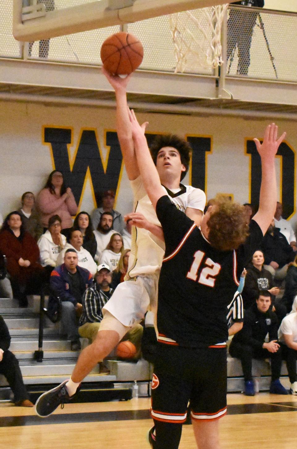 Westport's Owen Boudria goes up strong against Mount Greystone's Judge Martin.