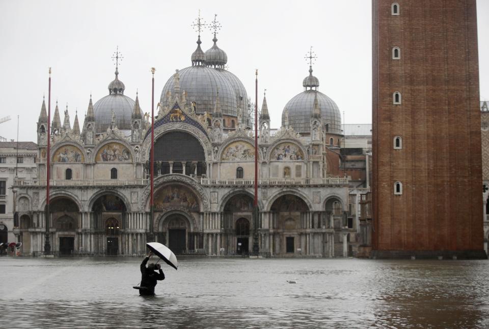 A photographer takes pictures in a flooded St. Mark's Square, in Venice, Italy, Tuesday, Nov. 12, 2019. (Photo: Luca Bruno/AP)