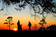 <p>(L-R) Ernie Els of South Africa with his caddie Cayce Kerr finish hitting chip shots on the practice area at sunset after the first round of The RSM Classic at the Sea Island Resort Seaside Course on November 16, 2017 in Sea Island, Georgia. (Photo by Stan Badz/PGA TOUR) </p>