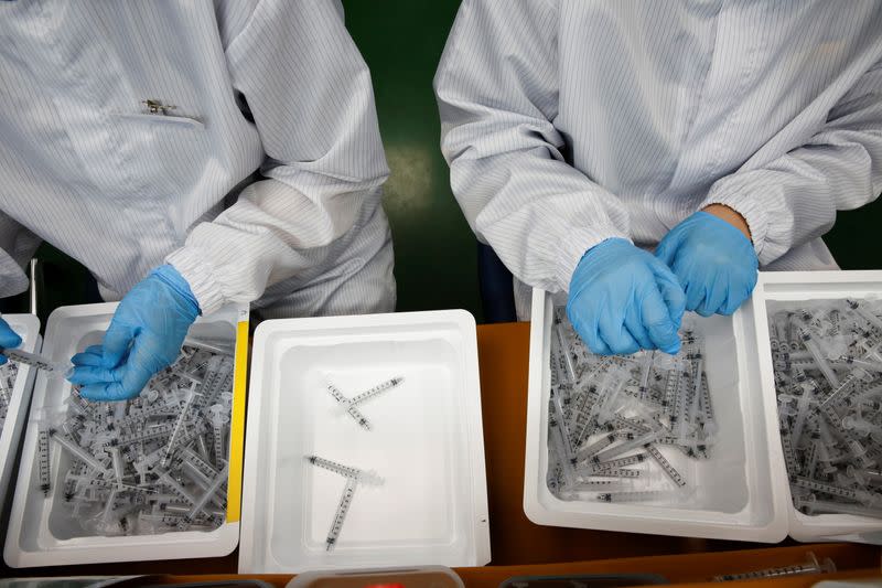 Employees work at a low dead space (LDS) syringe factory in Gunsan